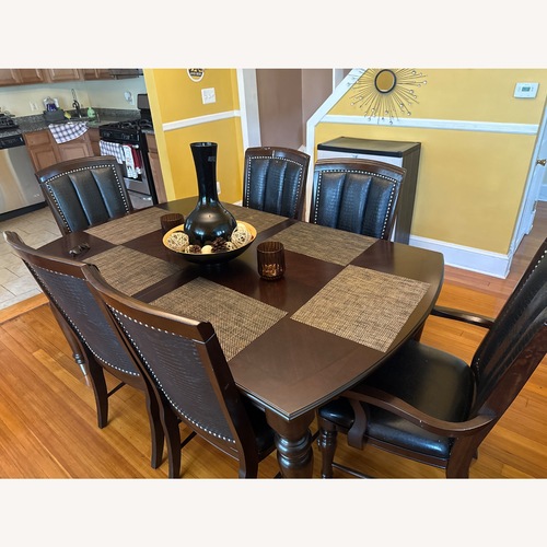 Used Dark Brown Wood Dining Table for sale on AptDeco