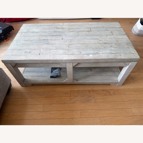 Used Ashley Furniture Fregine Gray Wood Lift Top Coffee Table for sale on AptDeco