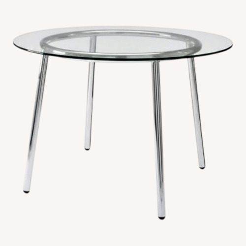 Used Round Glass Dining Table with Chrome Legs  for sale on AptDeco