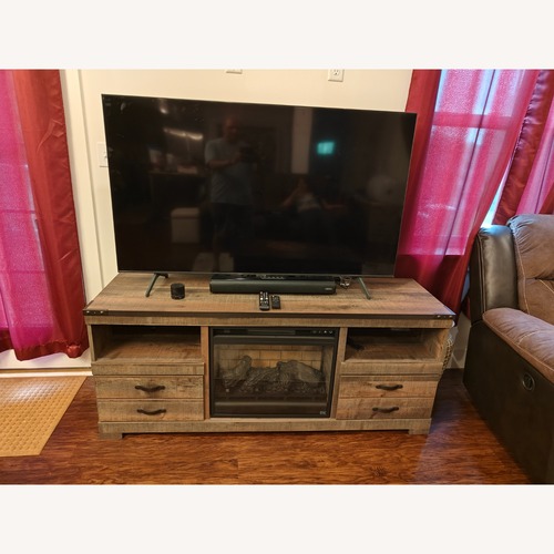 Used Ashley Furniture Trinell TV Stand with Electric Fireplace for sale on AptDeco