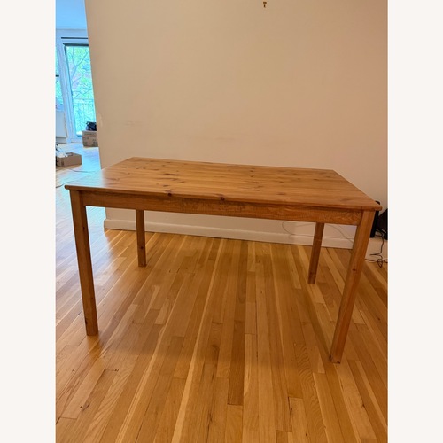 Used IKEA Natural Wood Dining Table for sale on AptDeco