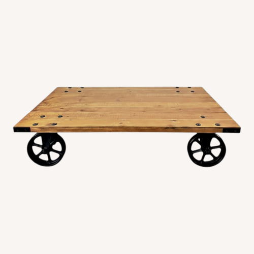 Used Pottery Barn Wheel Natural Coffee Table for sale on AptDeco