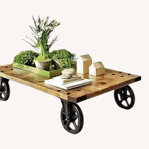 Used Pottery Barn Wheel Natural Coffee Table for sale on AptDeco