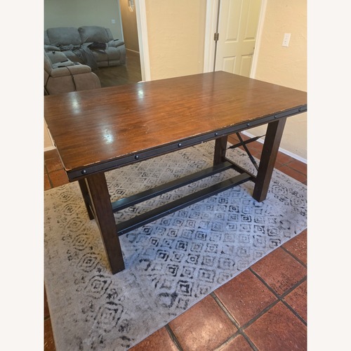 Used Dark Brown Wood Dining Table for sale on AptDeco