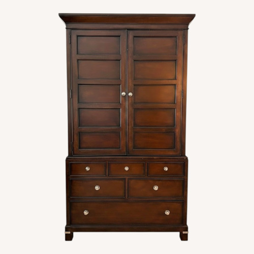 Used Macy's Dark Tea Trade Brown Wood Armoire for sale on AptDeco