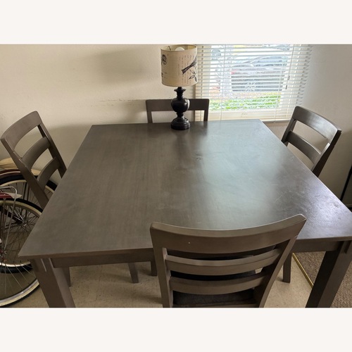Used Ashley Bridson Charcoal Gray Wood Dining Table + 4 Chairs for sale on AptDeco