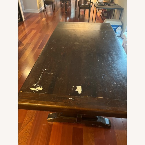 Used Dark Brown Wood Dining Table for sale on AptDeco