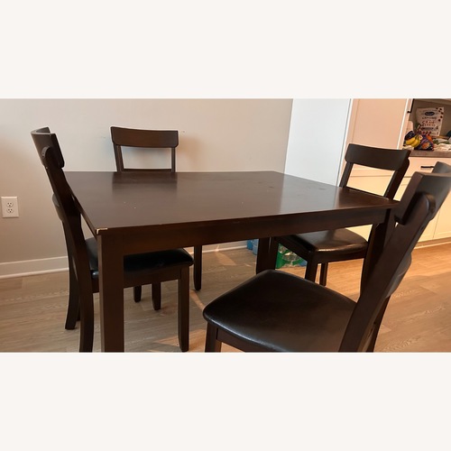 Used Ashley Furniture Dark Brown Wood Dining Table for sale on AptDeco