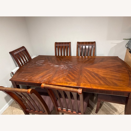Used Dark Brown Wood Dining Table for sale on AptDeco