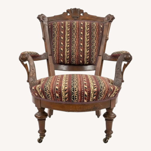 Used Carved Wood Armchair With Casters for sale on AptDeco