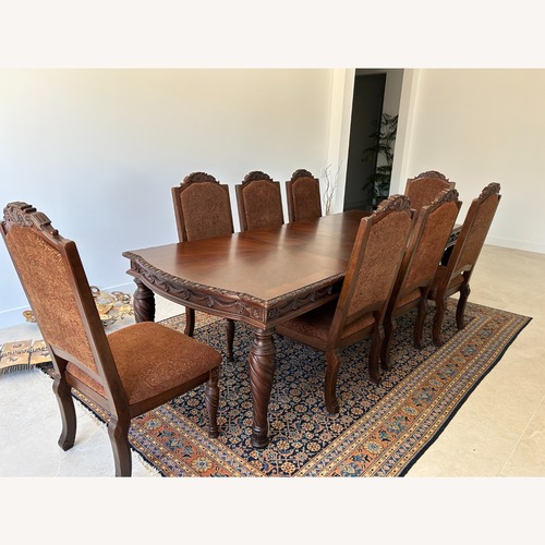 Used Ornate Wood Dining Table and 8 Chairs for sale on AptDeco