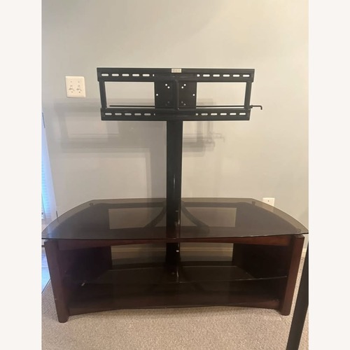Used 48" Wood/Smoked Glass TV Stand w Swivel TV Mount for sale on AptDeco