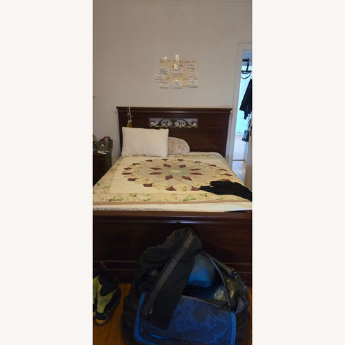 Used Dark Brown Wood Queen Bed for sale on AptDeco