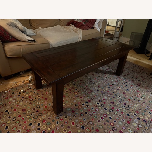 Used Pottery Barn Dark Brown Wood Coffee Table for sale on AptDeco