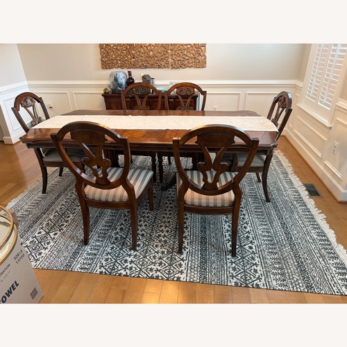 Used Ashley Furniture Dark Brown Wood Dining Table for sale on AptDeco