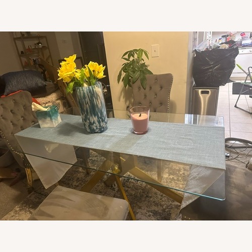 Used Gold and Glass Dinnete Table with 4 Gray Chairs for sale on AptDeco