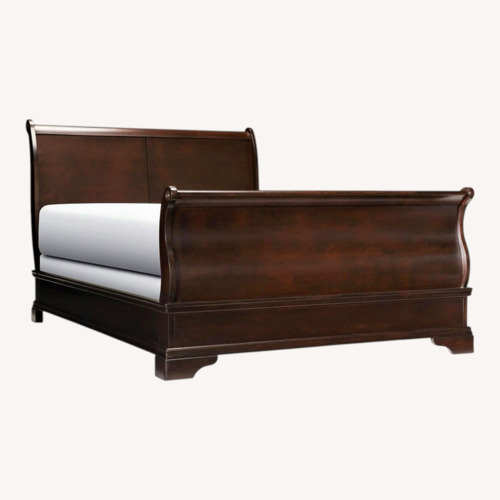 Used Raymour & Flanigan Dark Brown Wood Queen Bed for sale on AptDeco