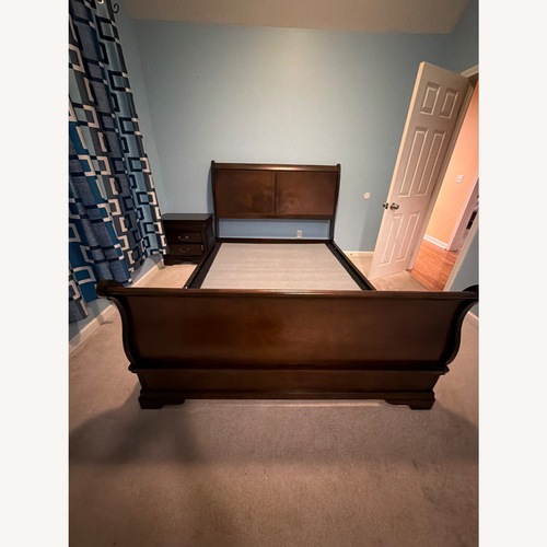 Used Raymour & Flanigan Dark Brown Wood Queen Bed for sale on AptDeco