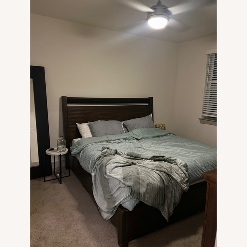 Used Ashley Dark Wood King Bed Frame and Headboard for sale on AptDeco