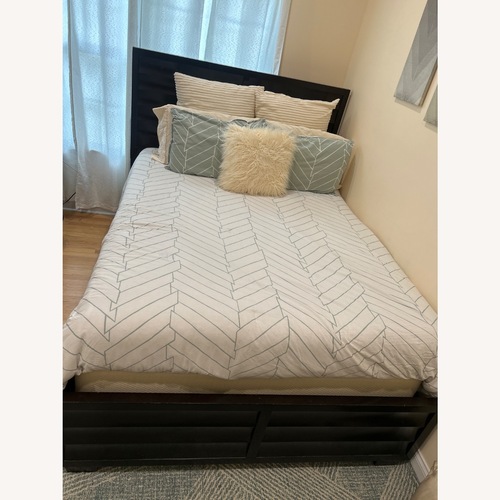 Used Macy's Dark Brown Wood Queen Bed for sale on AptDeco