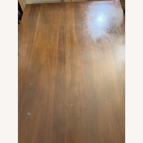 Used Dark Brown Wood Dining Table and 4 Chairs for sale on AptDeco