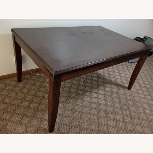 Used Dark Brown Wood Dining Table for sale on AptDeco