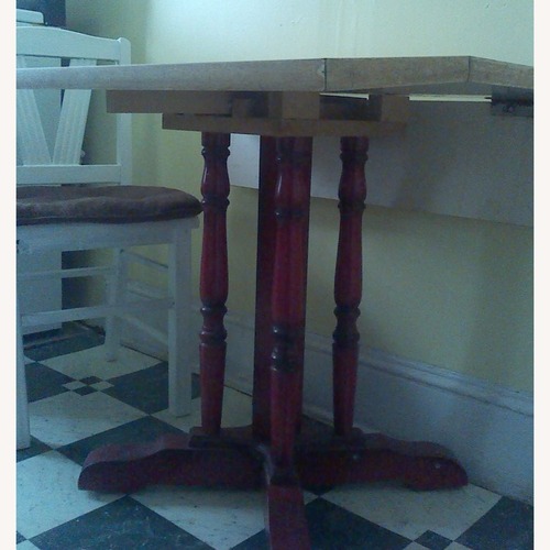Used Vintage Table With Drop Leaves and Red Carved Base for sale on AptDeco