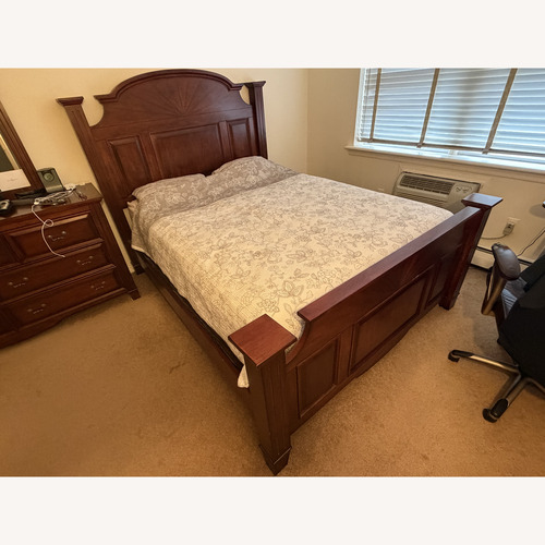 Used Raymour & Flanigan Dark Brown Wood Queen Bed for sale on AptDeco