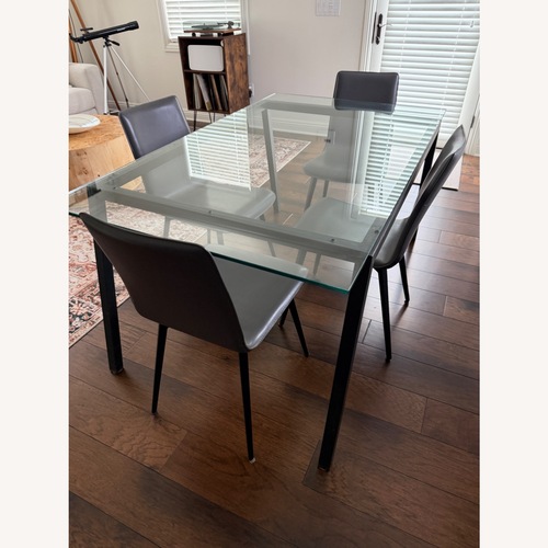 Used Room & Board Parsons Transparent Glass Dining Table for sale on AptDeco