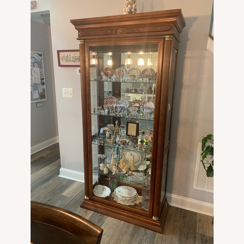Used Dark Brown Glass Armoire for sale on AptDeco
