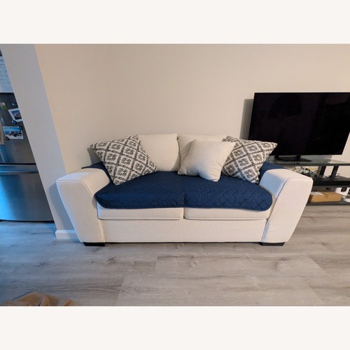 Used Living Spaces Large Cream Loveseat for sale on AptDeco