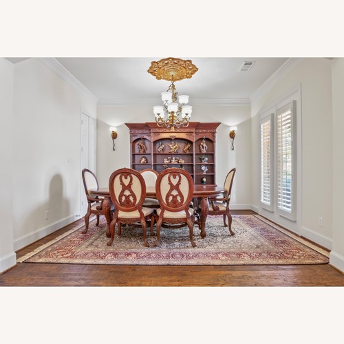 Used Dark Brown Wood Dining Table with Eight Chairs for sale on AptDeco