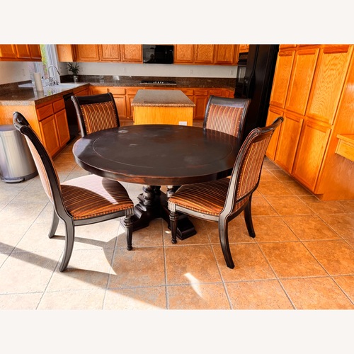 Used Dark Brown Wood Dining Table for sale on AptDeco