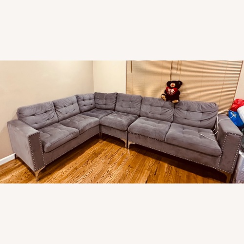 Used Comfy Grey Sectional with Silver Trim for sale on AptDeco
