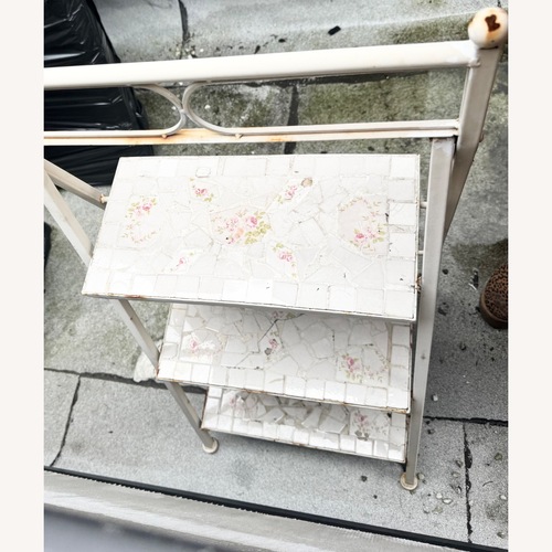 Used White Floral Metal Plant Display Stand Shelf for sale on AptDeco