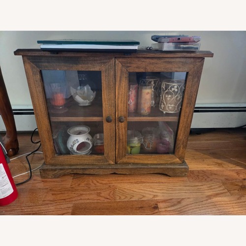 Used Compact 2-Door Wood & Glass Accent Cabinet for sale on AptDeco