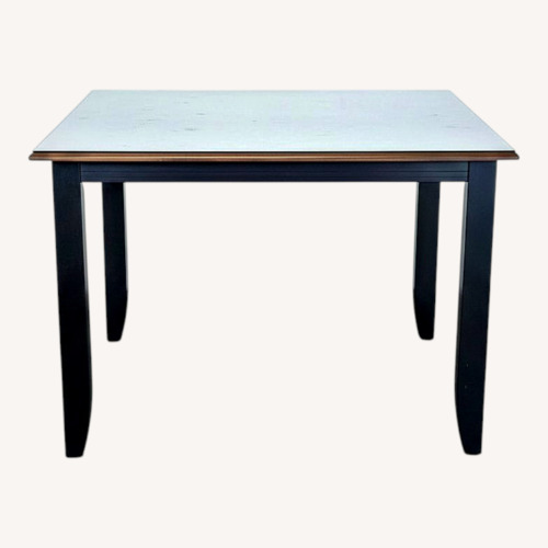 Used Wood Dining Table with Glass Protective Top	 for sale on AptDeco