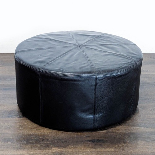 Used Round Leather Ottoman on Wheels	 for sale on AptDeco