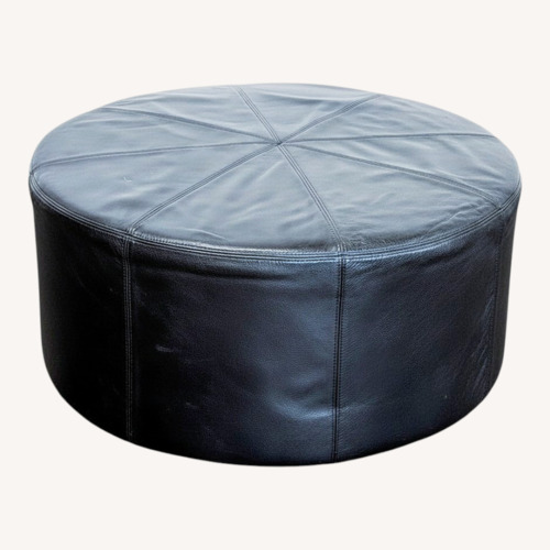 Used Round Leather Ottoman on Wheels	 for sale on AptDeco