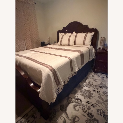 Used Rooms To Go Wood Queen Bed for sale on AptDeco