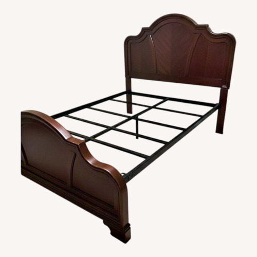 Used Rooms To Go Wood Queen Bed for sale on AptDeco