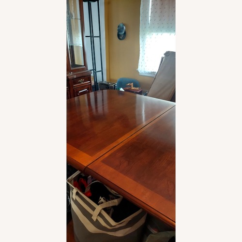 Used Dark Brown Wood Dining Table for sale on AptDeco