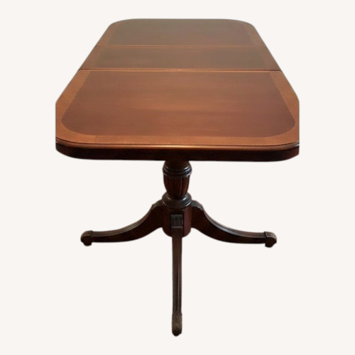 Used Dark Brown Wood Dining Table for sale on AptDeco