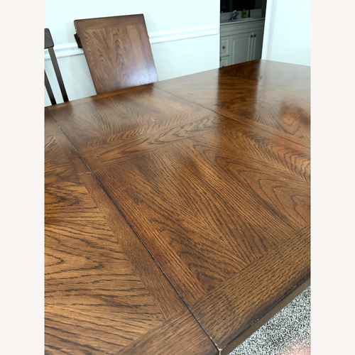 Used Dark Brown Wood Dining Table & Two Leaves for sale on AptDeco