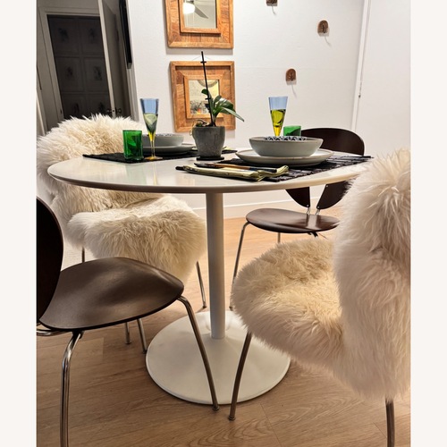 Used CB2 Odyssey Round White Tulip Dining Table for sale on AptDeco