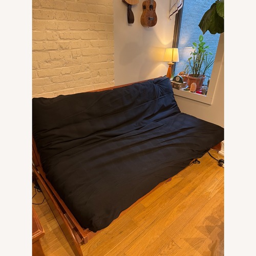 Used Wooden Sofa Bed With Black Futon for sale on AptDeco