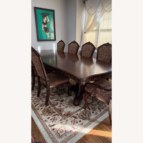 Used Raymour & Flanigan Dark Brown Wood Dining Table for sale on AptDeco
