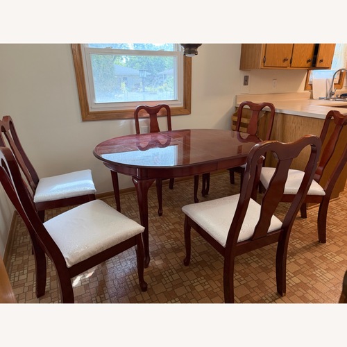 Used Dark Brown Wood Dining Set with Leaf for sale on AptDeco