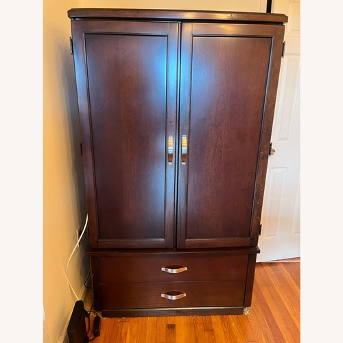 Used Dark Brown Wood Armoire for sale on AptDeco
