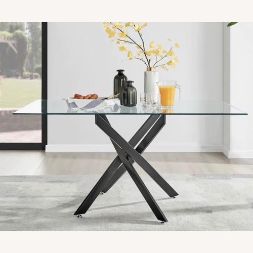 Used Glass Dining Table With Modern Black Base for sale on AptDeco